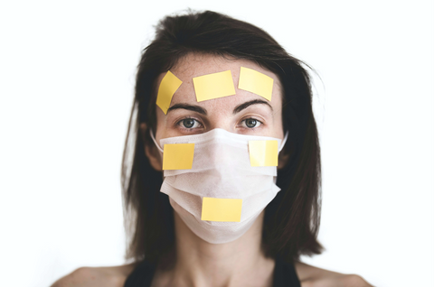 Woman wearing a face mask with tape