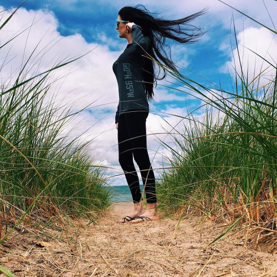 Seattle standing on a beach in a 60°N 95°W women's henley