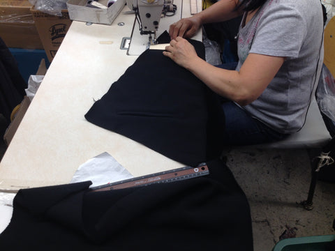 A seamstress sews a fleec sweater with precision.