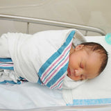 preemie baby sleeping swaddled in hospital blanket
