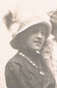 A Victorian Lady wearing a necklace featuring her collection of Love Tokens.