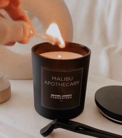 Custom Candle in Matte Black Being Burned with a Match by Malibu Apothecary