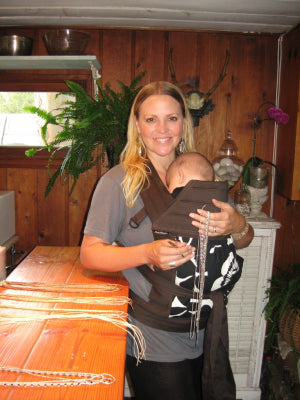 heather gardner working on jewelry with baby hawk carrier