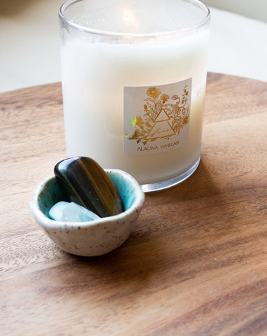 fire element candle with small ceramic bowl filled with gemstones