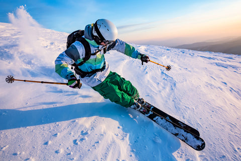 Man skiing on a snowy slope with dry ski boots