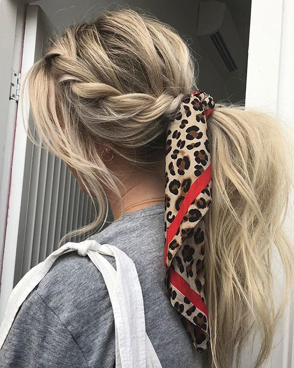 Leopard print silk scarf worn as a hair accessory