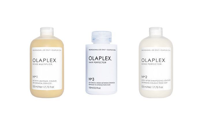 Olaplex No.1, 2 and 3 hair treatment product bottles on white background