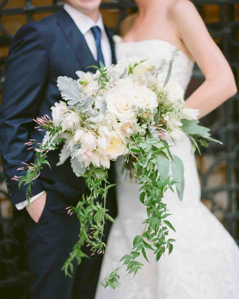 Bridal bouquet with roses, dusty miller and protea