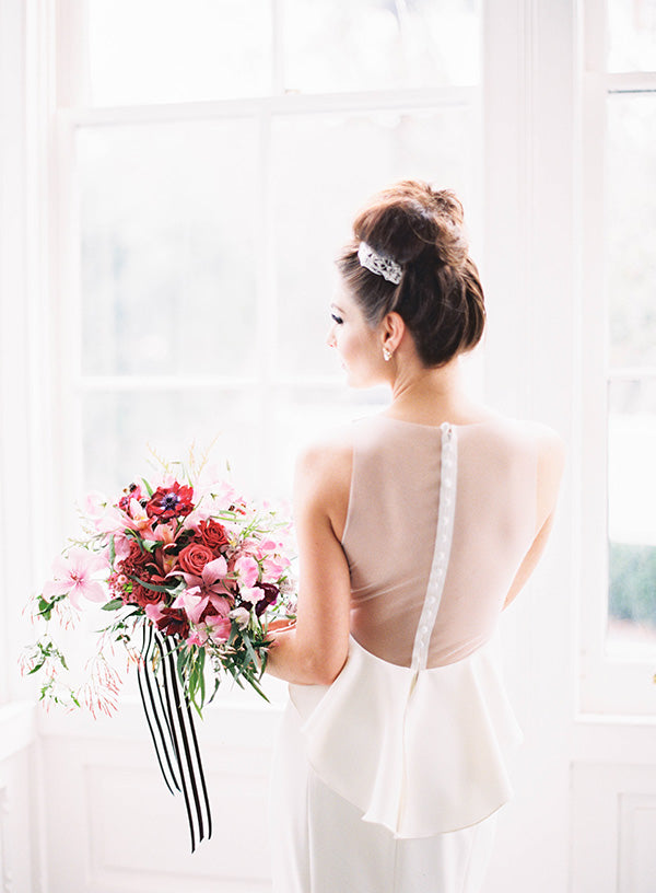 Bride holding bouquet with striped ribbon