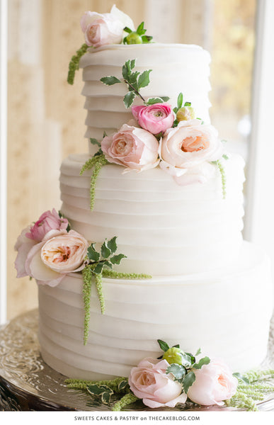 Wedding cake with pink flowers and greenery