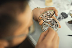 Watchmaker working on a watch in workshop