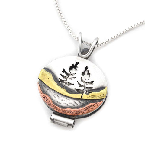 Beth Millner Jewelry Two Hearted River Locket handcrafted mixed metal pendant with trees and nature