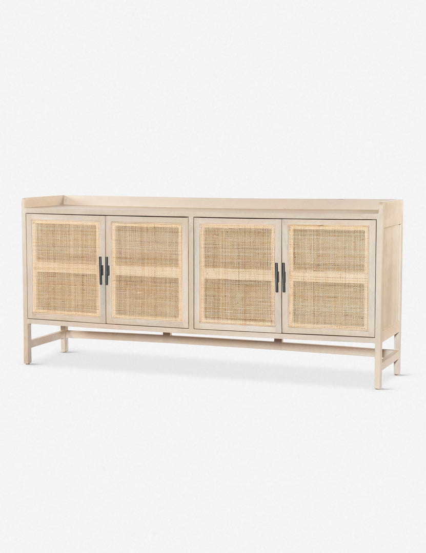 Angled view of the Philene natural mango wood sideboard with cane doors