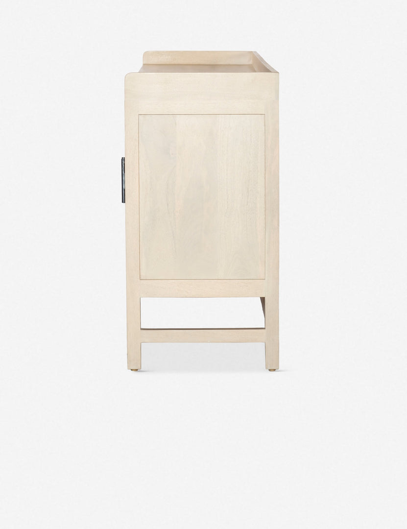 Side view of the Philene natural mango wood sideboard with cane doors