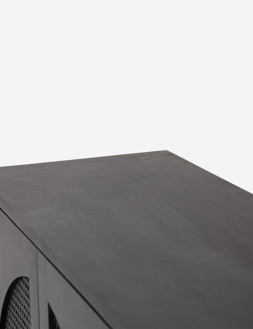 Close-up of the top of the Islay black wood Moroccan-style sideboard with arched cane door panels