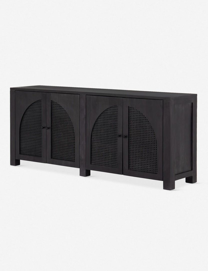 Angled right view of the Islay black wood Moroccan-style sideboard with arched cane door panels