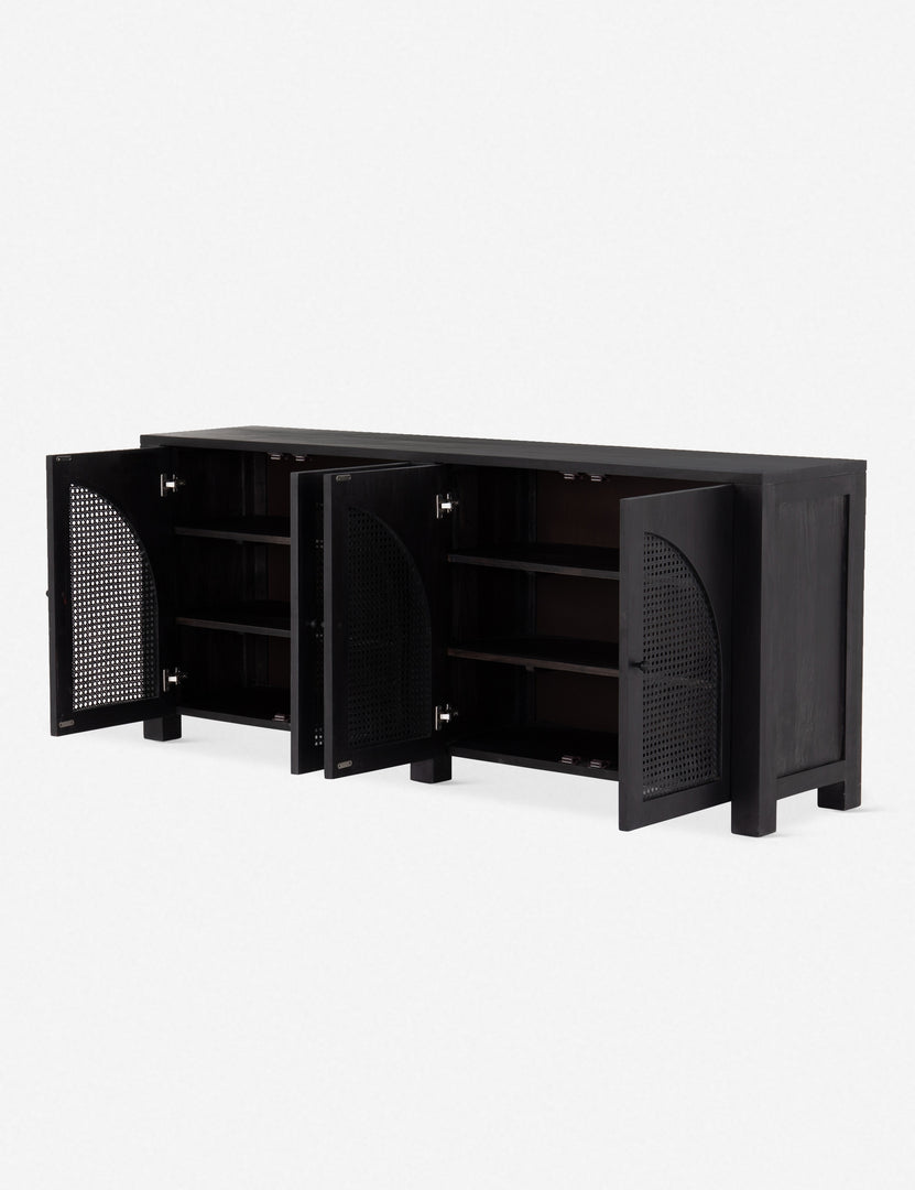 Angled right view with doors open of the Islay black wood Moroccan-style sideboard with arched cane door panels