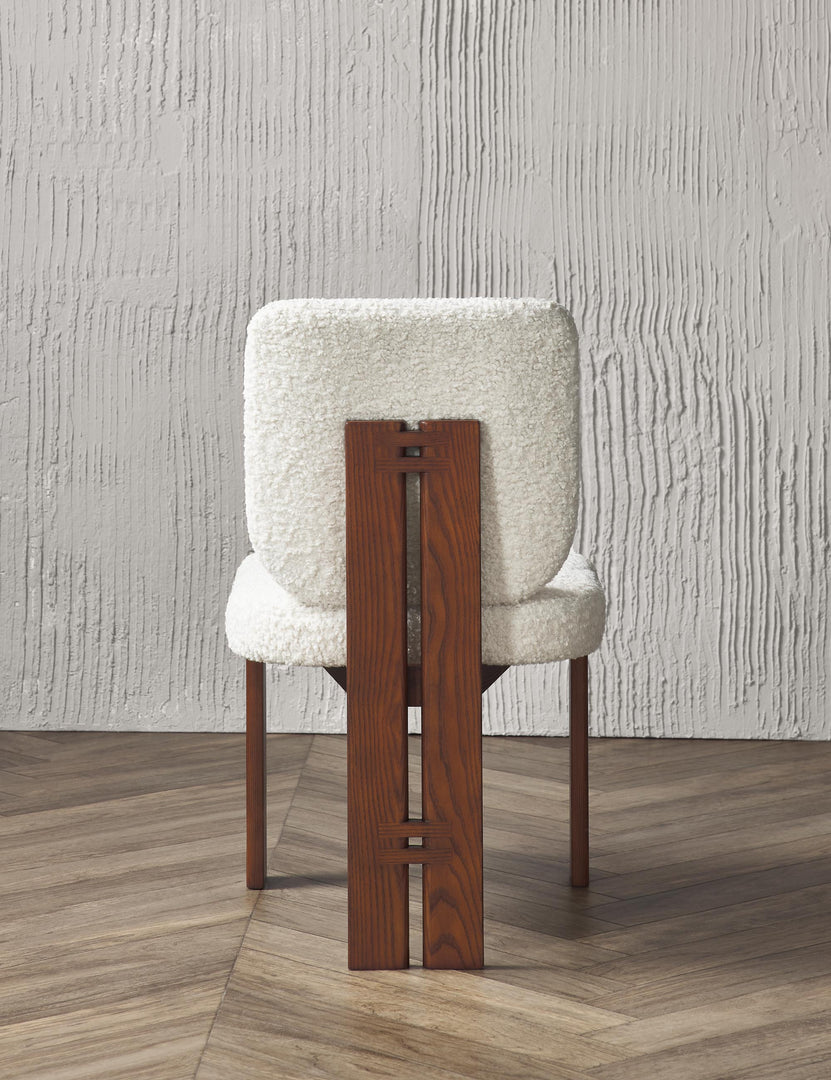 Rear view of the Sydney white plush armless dining chair sitting on chevron hardwood flooring with a texture white wall in the background.