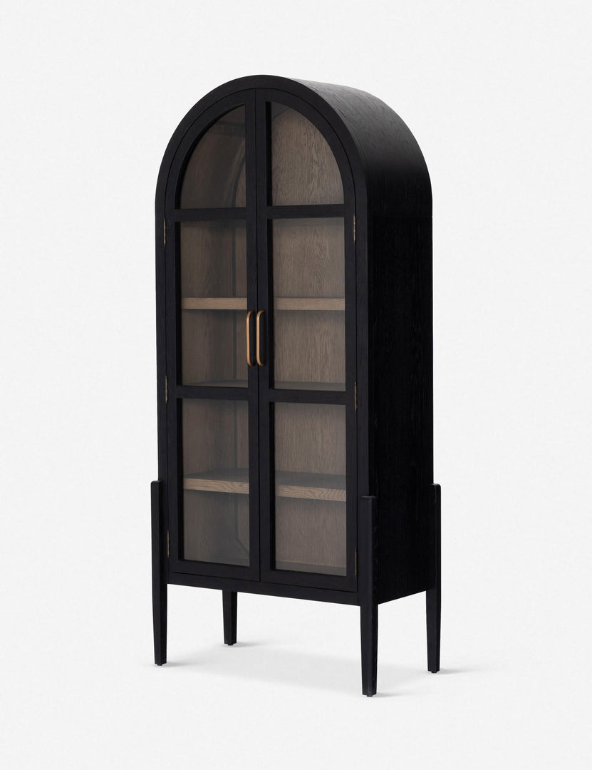 Angled right view of the Apolline black wooden arched curio cabinet with gold door handles