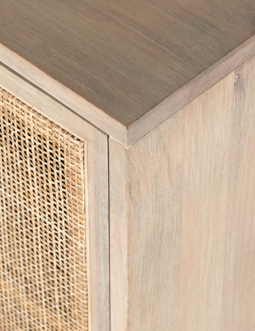 Detailed view of the upper corner of the Margot whitewashed natural mango wood sideboard with cane doors.