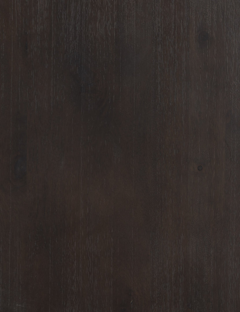 Detailed view of the black mango wood on the surface of the Margot black mango wood sideboard with cane doors.
