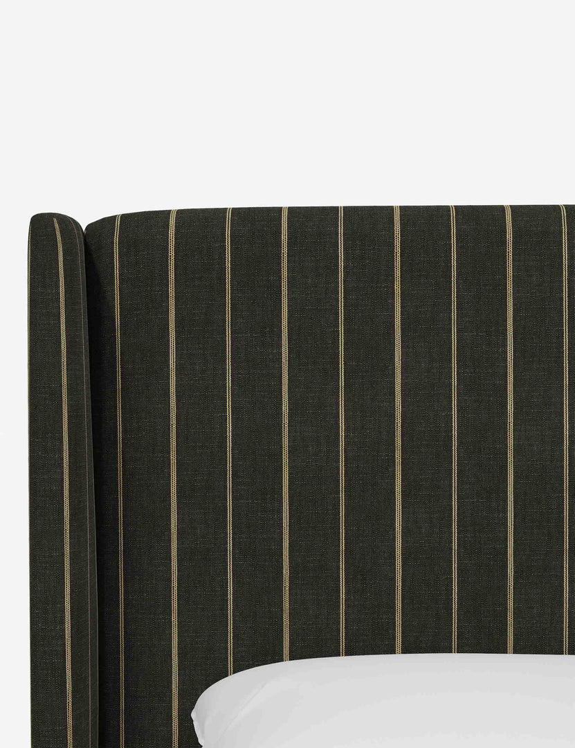 Close-up of the subtle winged headboard and trim lines on the Adara peppercorn stripe linen upholstered bed.