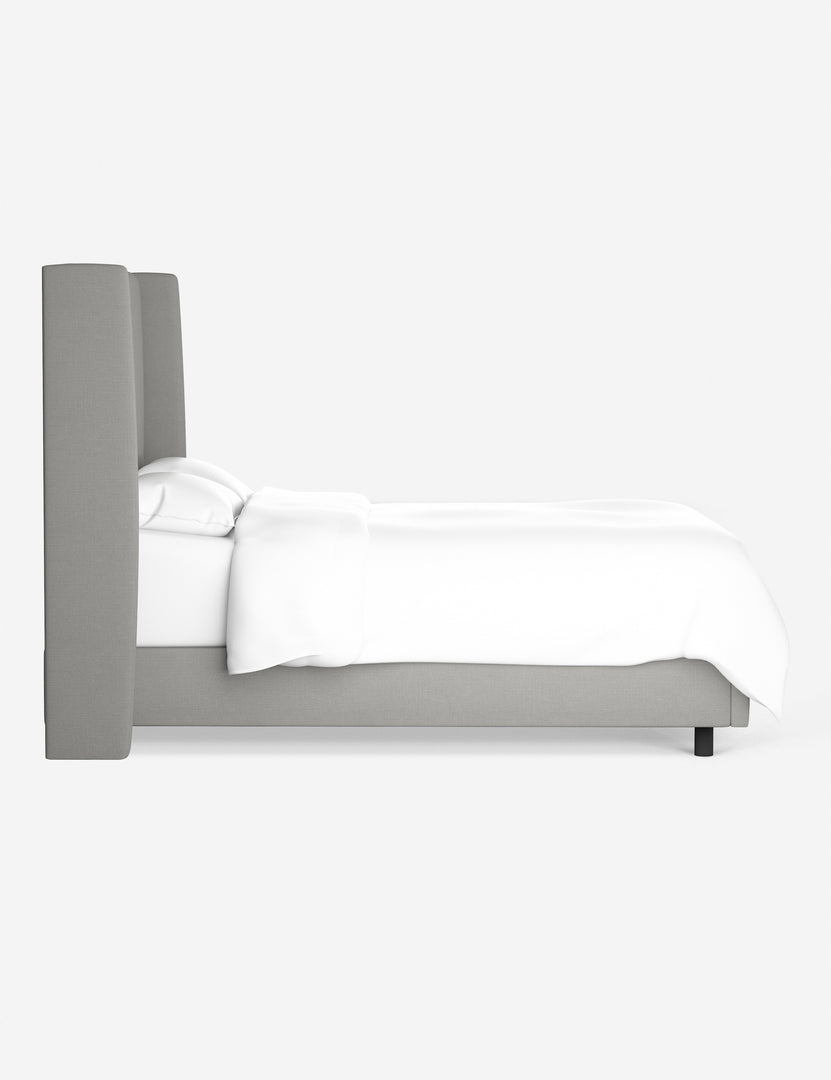 Side view of the Adara gray linen upholstered bed.