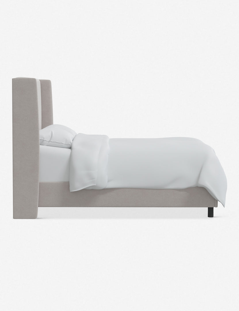 Side view of Adara ivory velvet upholstered bed.