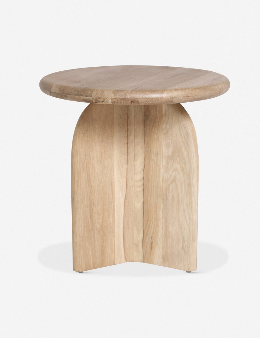 Side view of the Ada solid oak side table with oval top and curved pedestal base