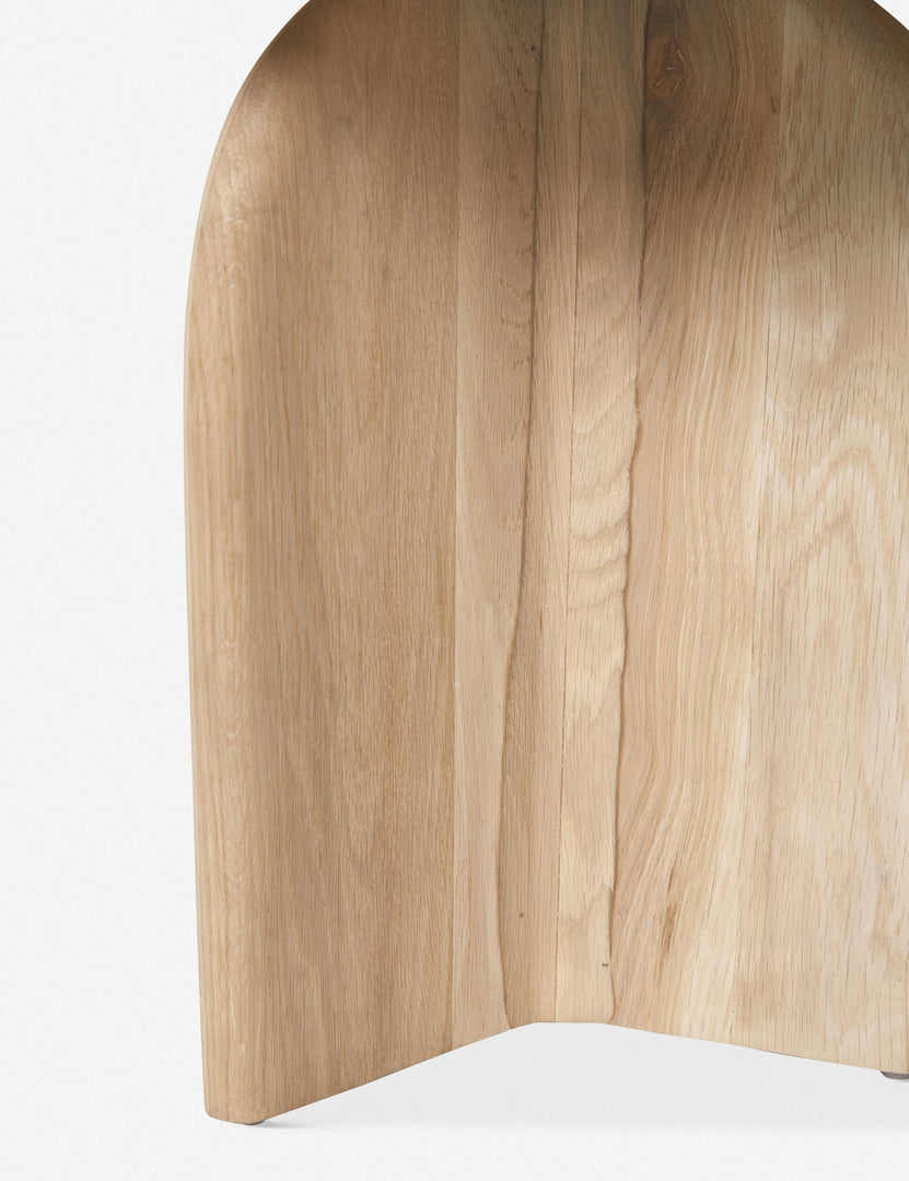 Close-up of a leg on the Ada solid oak side table with oval top and curved pedestal base