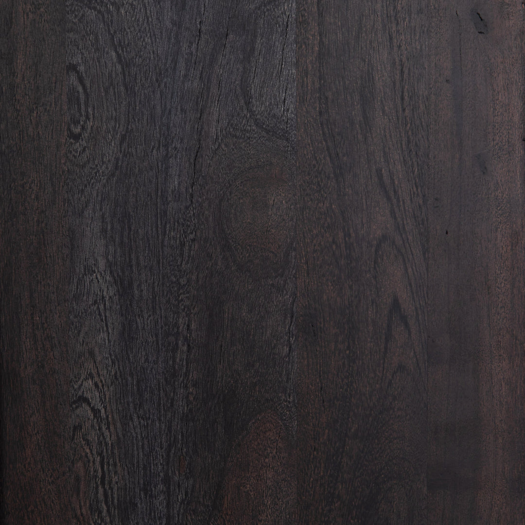 Detailed view of the black mango wood on the Hannah black mango wood cabinet with cane doors