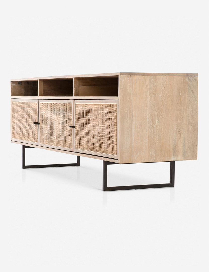 Angled view of the Hannah natural mango wood media console with cane doors.