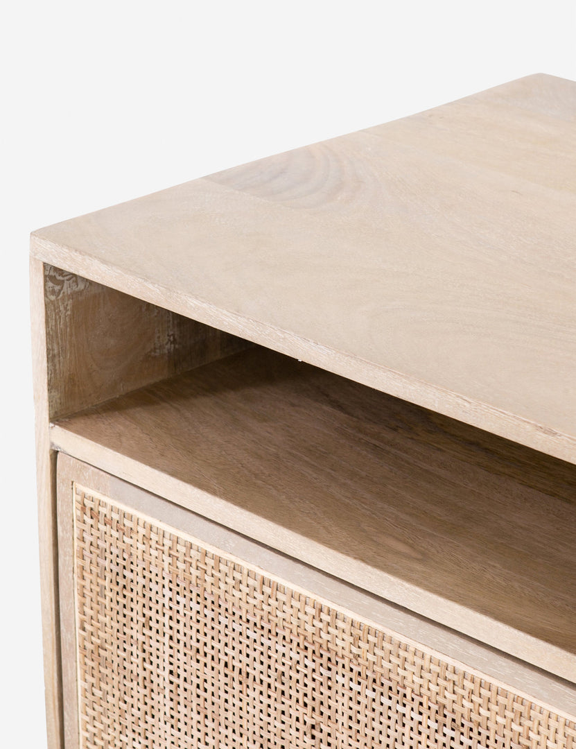 Close-up of the cane doors and the open shelving on the top of the Hannah natural wood mango media console.