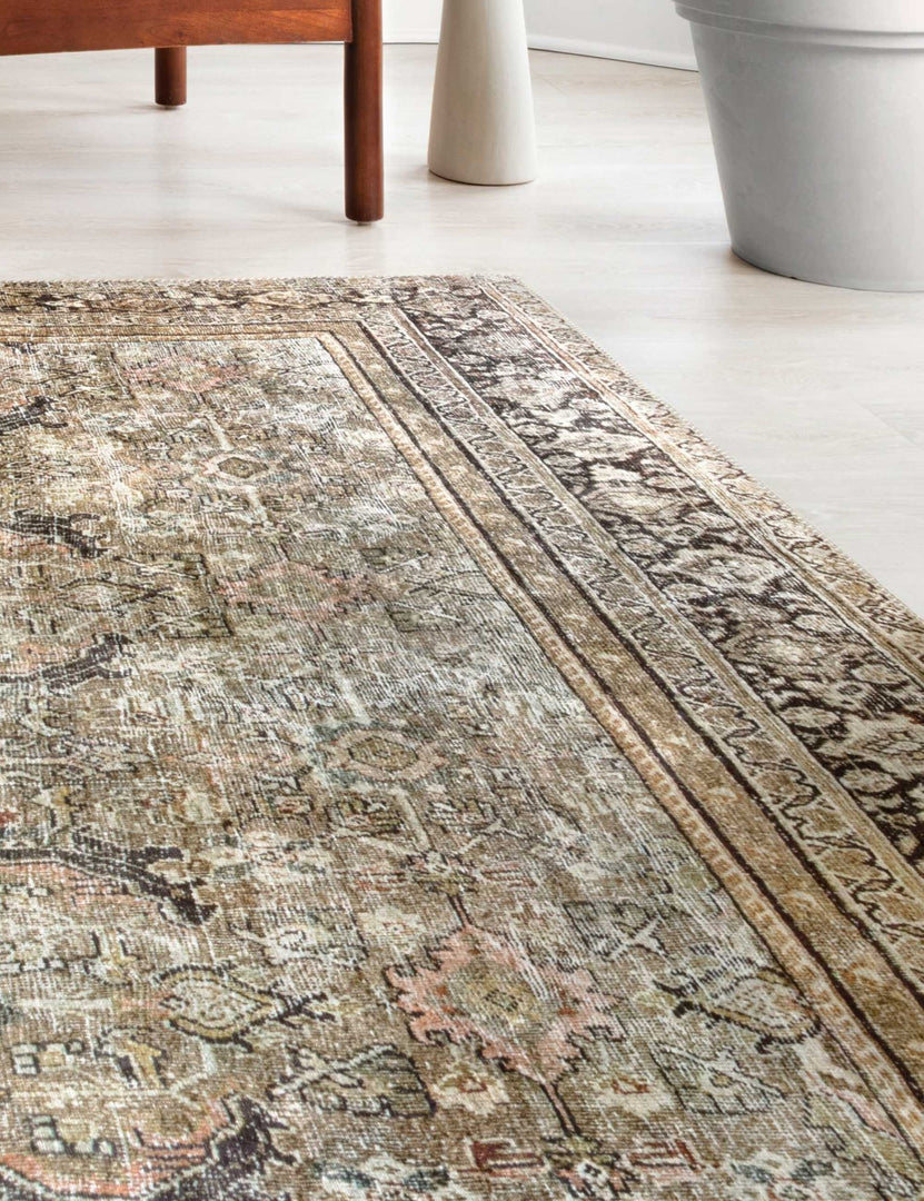 Close-up angled view of the Dacion distressed dark-toned persian rug