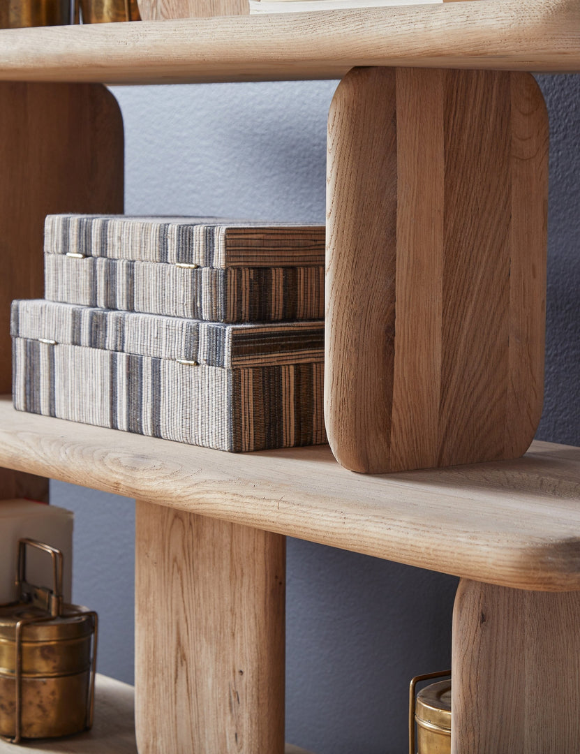 Angled close up of the Nera natural solid wood sculptural bookcase