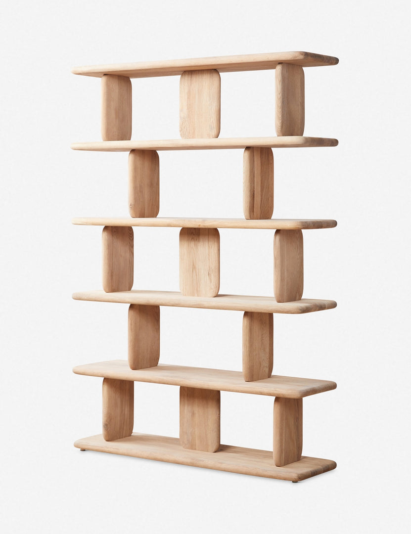 Angled view of the Nera natural solid wood sculptural bookcase