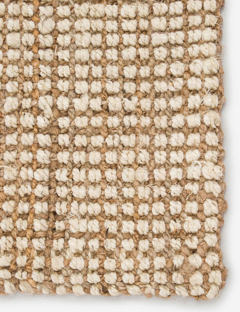 Close-up of the corner of the Harriette scandinavian-inspired rug made of 100% jute