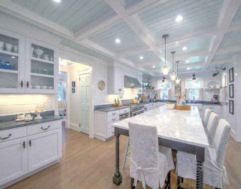 Blue shiplap ceiling with white beams in eclectic kitchen