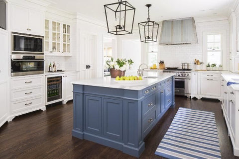 Large blue kitchen island with white cabinetswood floors and black and blue accents