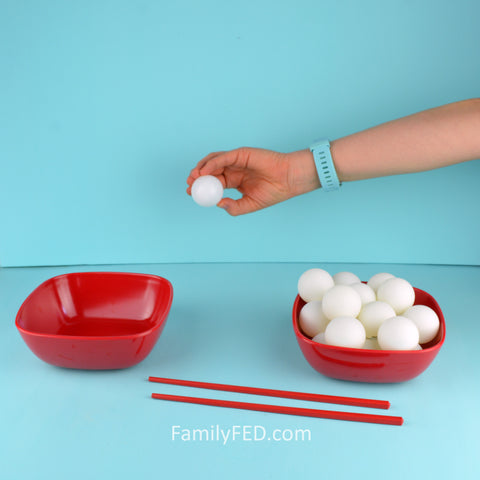 Make the Backward Ball Drop game easier by using hands instead of chopsticks.
