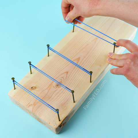 Add rubber bands around the nails on Family FED's DIY Board Bounce game