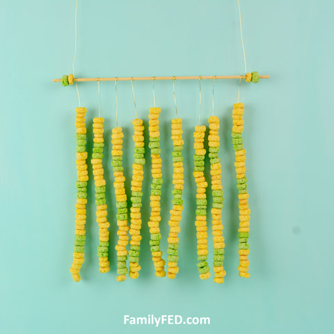Make a wall hanging with skewer sticks and Fruit Loops. A Fruit Loops Arts and Crafts—a Creativity Exercise with Fun and Food