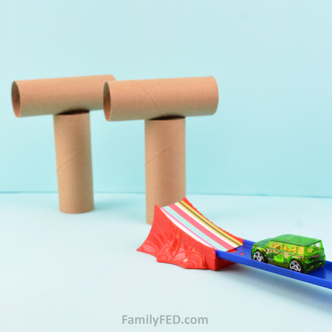 Easy game for Onward movie night idea with toilet paper rolls and Hot Wheels cars and launching tracks
