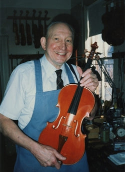 Carl F. Becker holding a violin