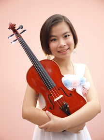 Young girl holding a violin