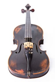 An old violin on a white background