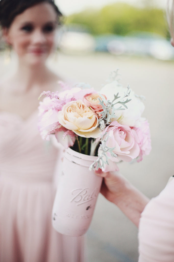 Love these bridesmaid bouquets in pink mason jars! | A Whimsical Gold and Pink Wedding Day