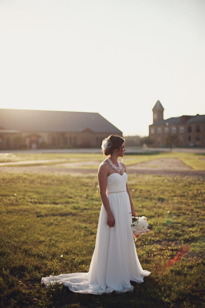 A stunning ivory, chiffon bridal gown. | A Whimsical Gold and Pink Wedding Day