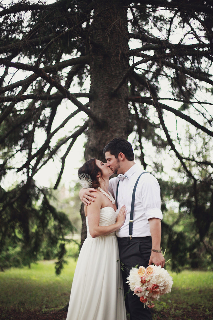 A bride in along, chiffon wedding dress and a groom in suspenders is the perfect, rustic combination! | A Whimsical Gold and Pink Wedding Day