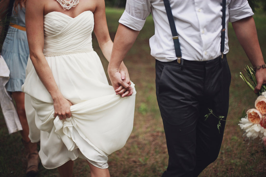 A flowing, chiffon wedding dress, perfect for a rustic chic wedding day. | A Whimsical Gold and Pink Wedding Day